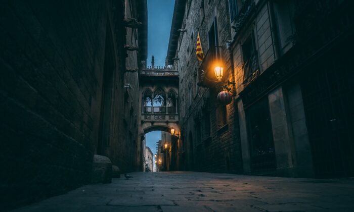 a narrow alley way with a light on at night
